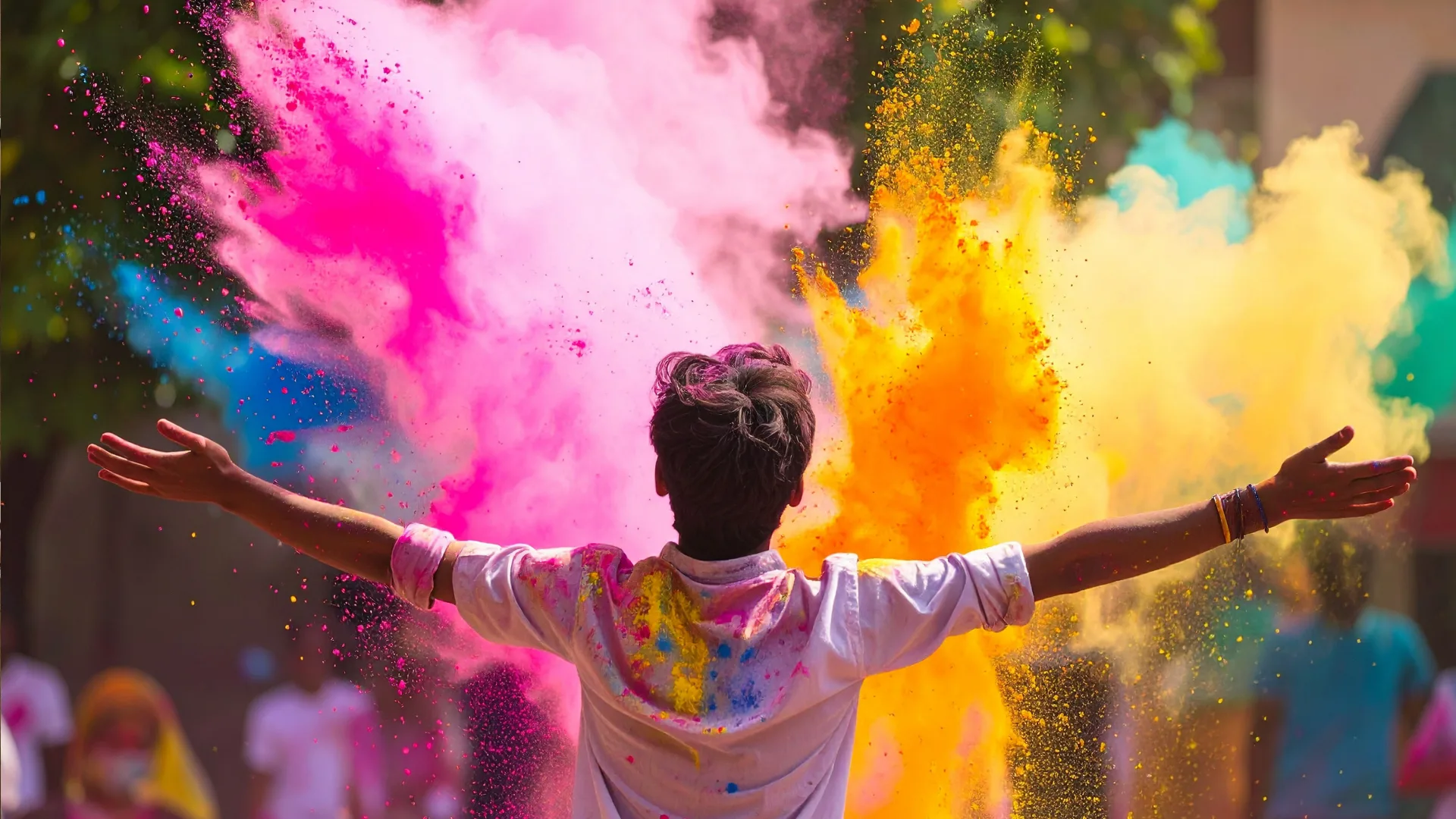 Person bursting through a cloud of brightly coloured powder, arms wide